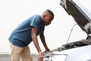 man looking at the car radiator