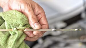 man checking dip stick before oil change